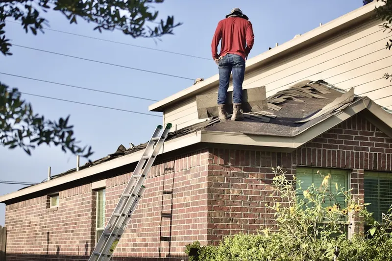 Professional roofer working on a residential roof in Beaver Island